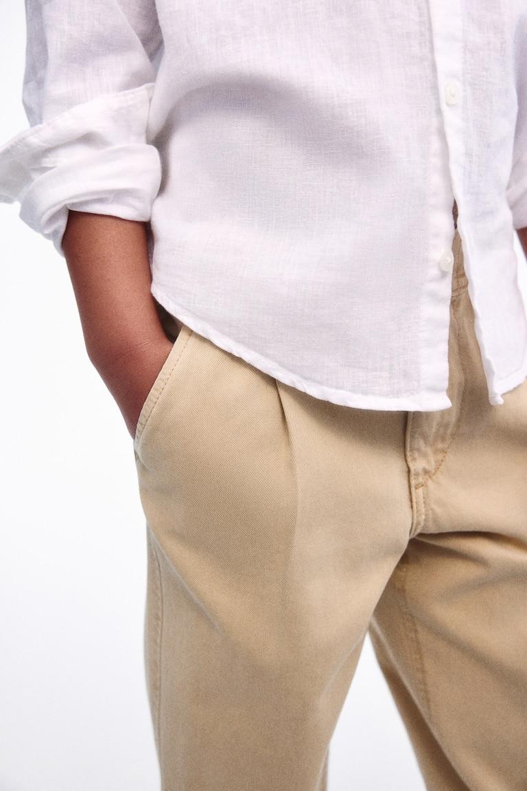H&M Loose-fit tapered twill chinos Neuheiten